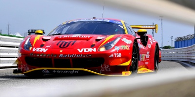 Ferrari vermelha e amarela do GT Italiano com foto tirada de dentro dos vãos de um guard-rail